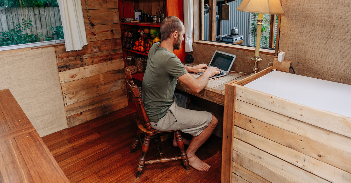 Robin Greenfield - Living Simply in a Tiny House, Robin on computer 2019 - credit www.sierraford.com